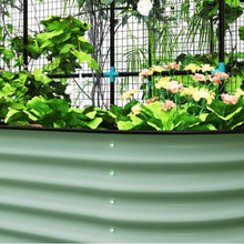 Load image into Gallery viewer, Green metal raised garden bed with plants and flowers inside