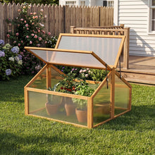 Load image into Gallery viewer, Wooden cold frame with transparent lid on a grassy area, surrounded by plants and flowers.